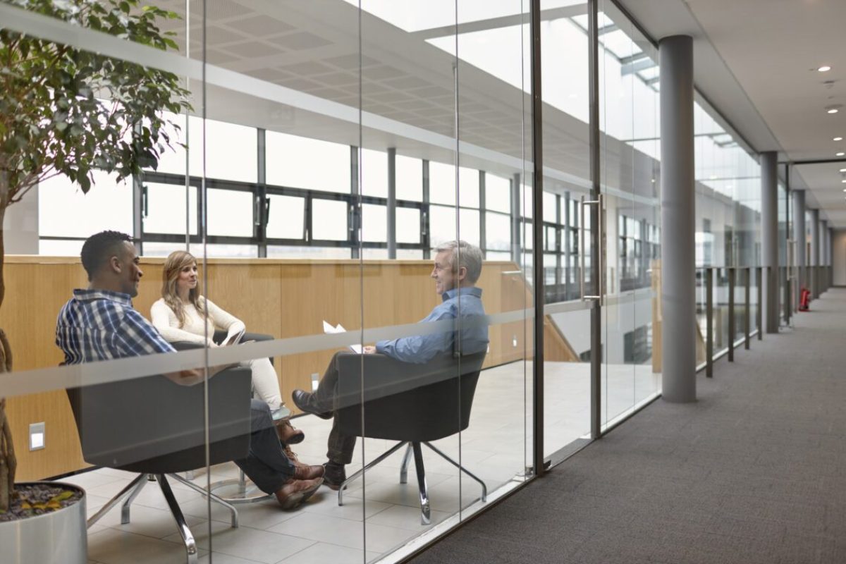 Businessmen and woman talking at conference room meeting