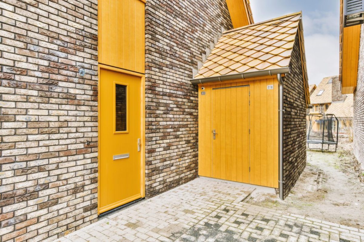 Entrance to residential cottages made of bricks with wooden inserts