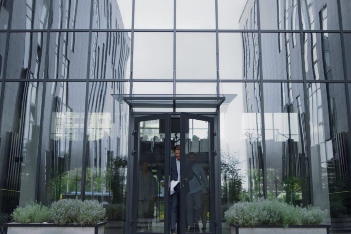 Frustrated businessman throwing papers at office entrance. Team failure concept. Annoyed dissatisfied employees leave building after critical meeting. Stressed coworkers blame disrespect upset manager