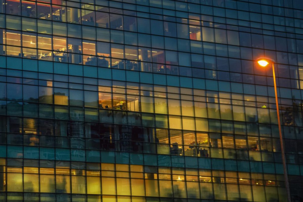 Glazed facade of an office building with a lamppost in front