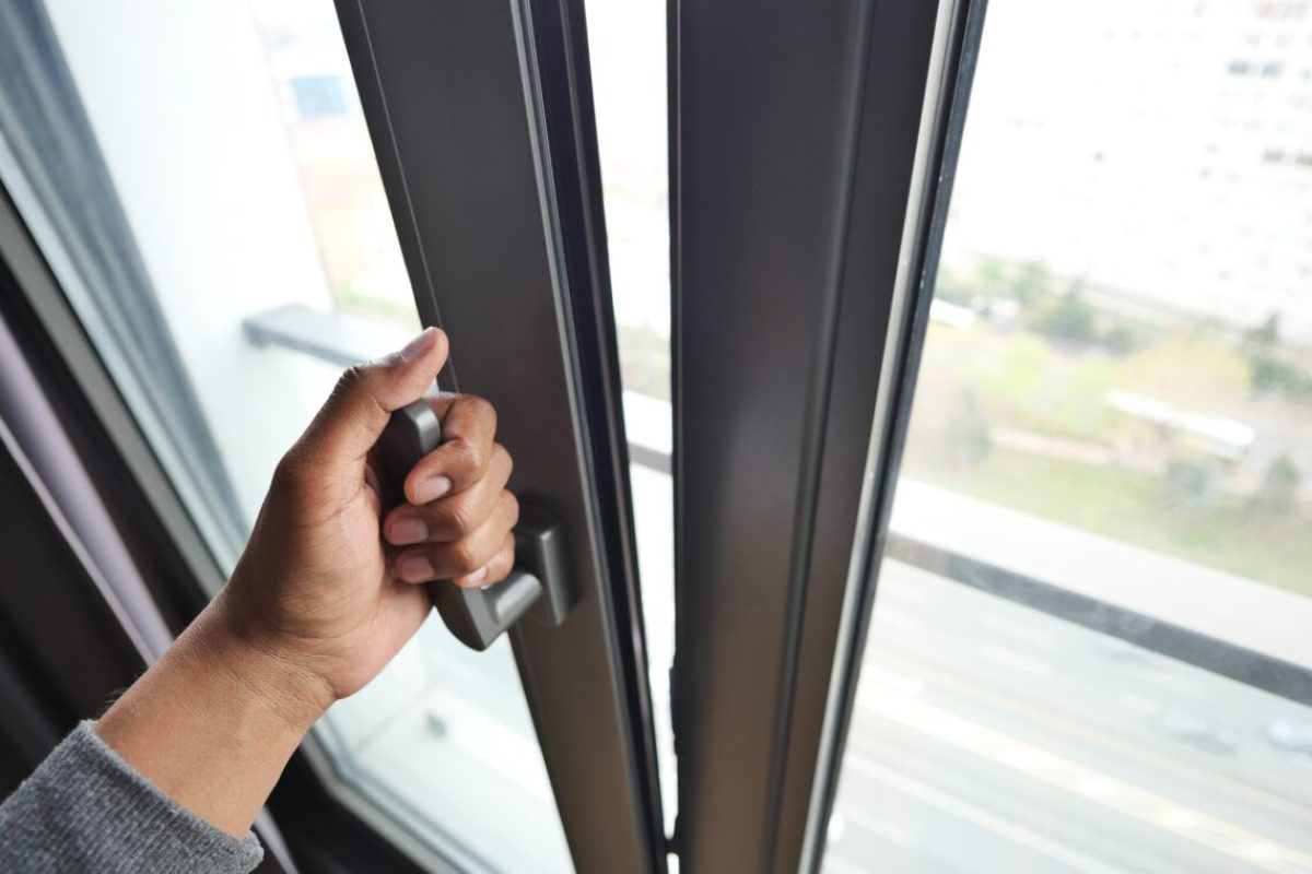 hand open gray plastic pvc window at home