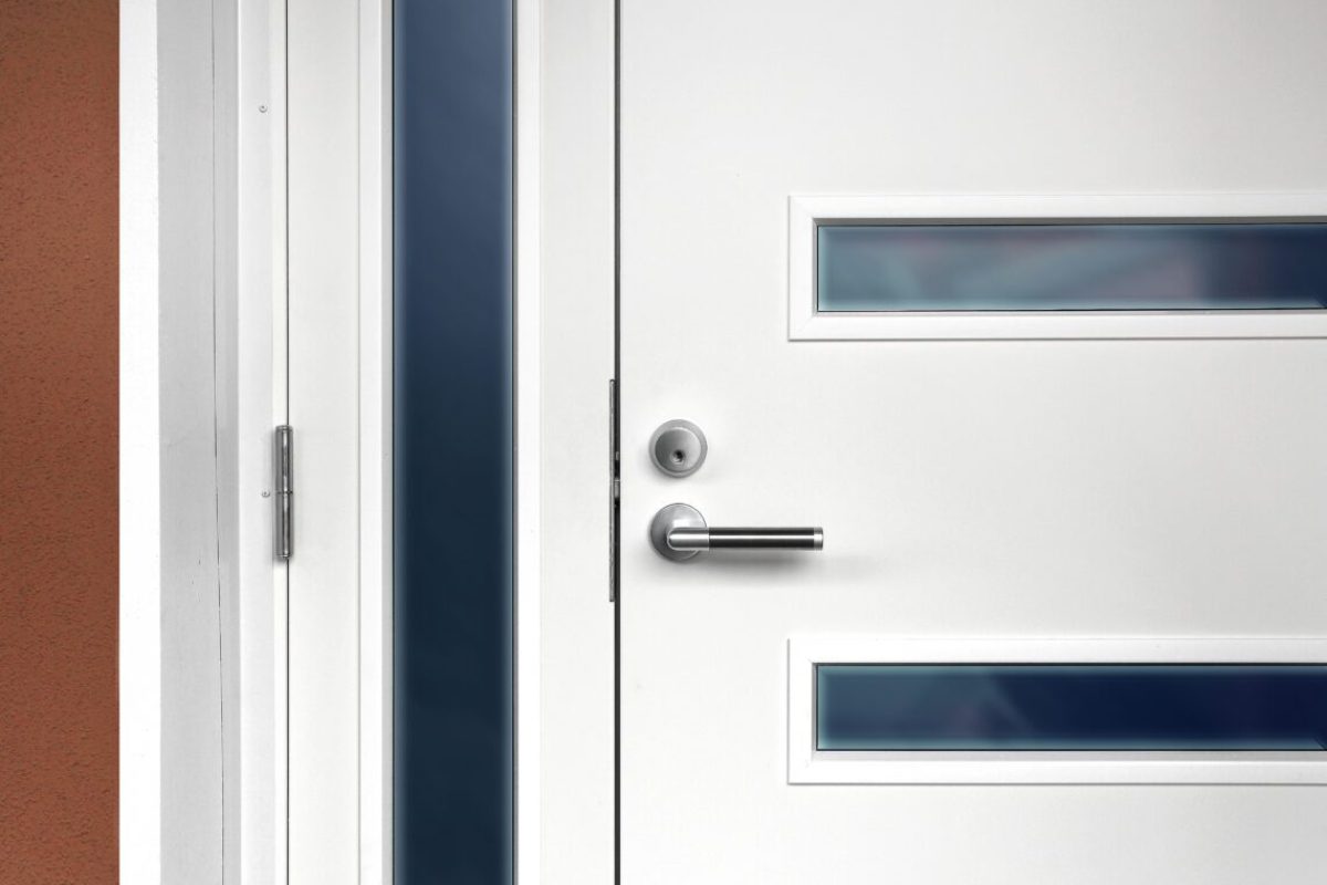 Modern white front door with metal fixture handle and glass windows