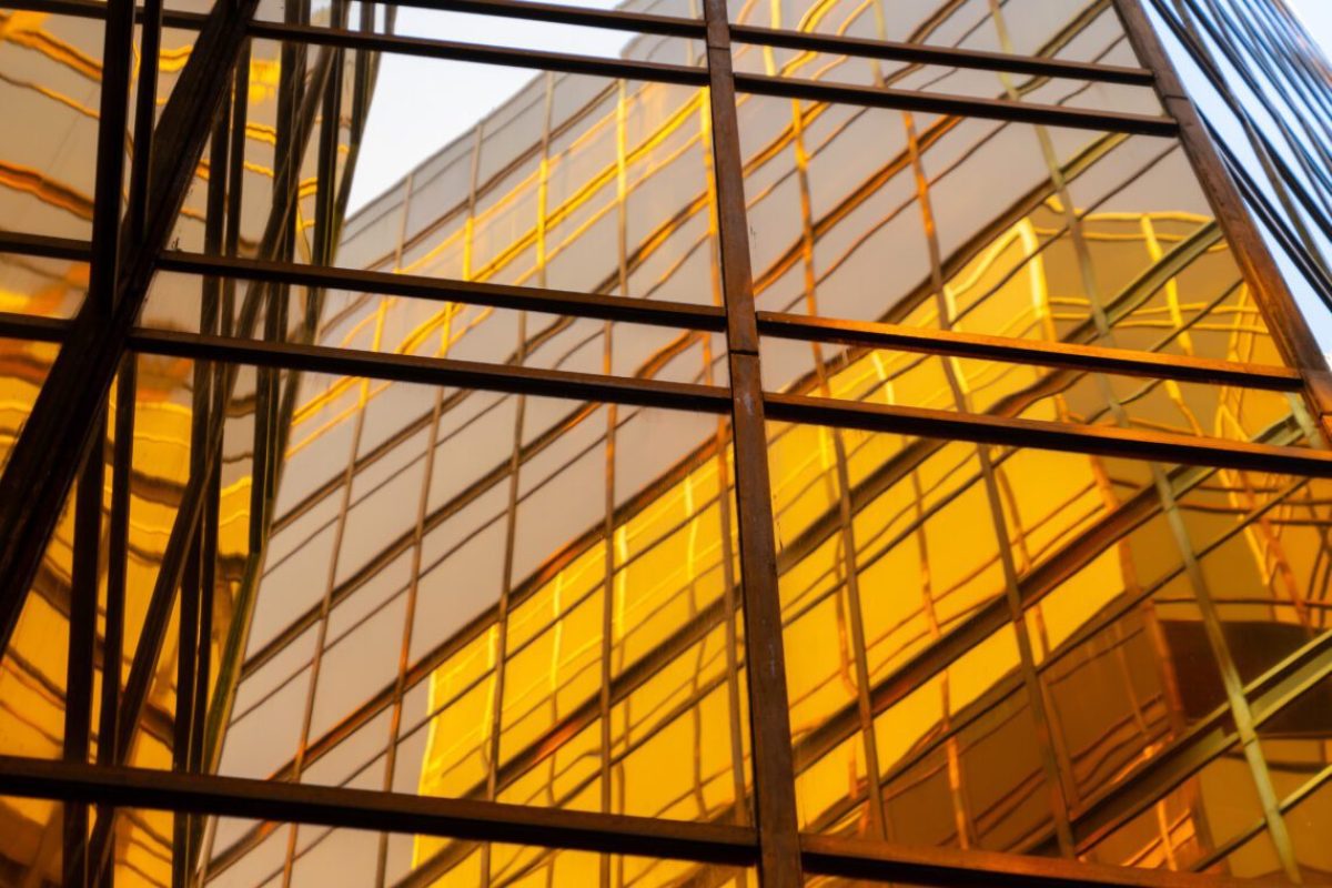 Golden building. Windows glass of modern office skyscrapers in technology and business concept. Facade design. Construction structure of architecture or engineering. Exterior for urban city background